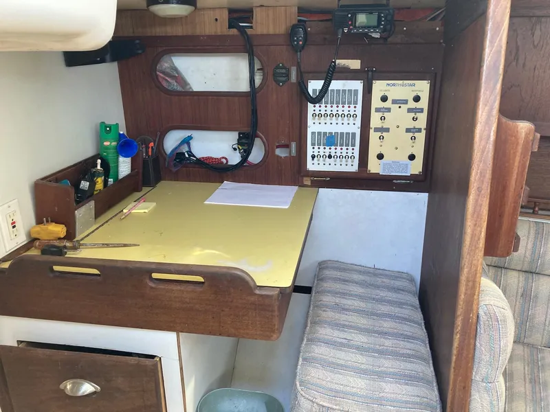 Slide: The Image of 1975 Northstar Hughs Northstar 80/20 Center Cockpit interior with navigation station and control panel. - 15
