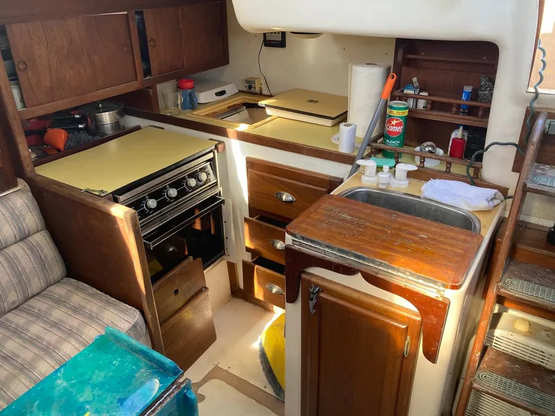 Slide: The Image of 1975 Northstar Hughs Northstar 80/20 Center Cockpit yacht interior kitchen with stove and sink. - 16