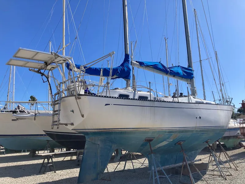 Slide: The Image of 1975 Northstar Hughs Northstar 80/20 sailboat on stands, blue sky background. - 4