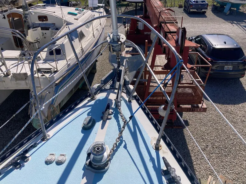 Slide: The Image of 1975 Northstar Hughs Northstar 80/20 Center Cockpit sailboat on dry dock, surrounded by equipment. - 9