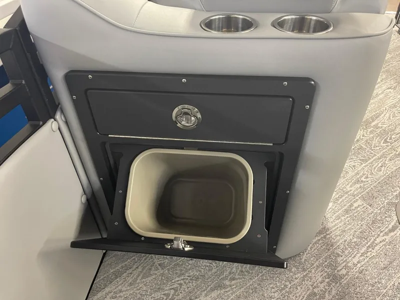 Slide: The Image of 2025 JC Neptoon 23 TT DSL boat interior with built-in trash compartment and cup holders. - 17