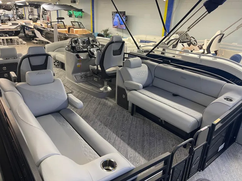 Slide: The Image of 2025 JC Neptoon 23 TT DSL pontoon boat interior with luxurious seating and modern dashboard. - 23