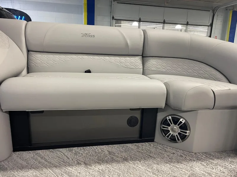 Slide: The Image of 2025 JC Neptoon 23 TT DSL pontoon boat interior with plush seating and speaker system. - 26