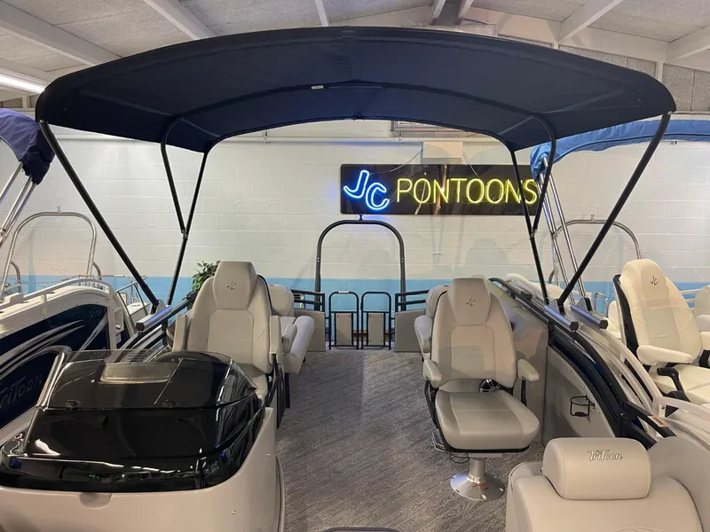 Slide: The Image of 2025 JC Neptoon 23 TT DSL pontoon boat interior with seating and canopy. - 27