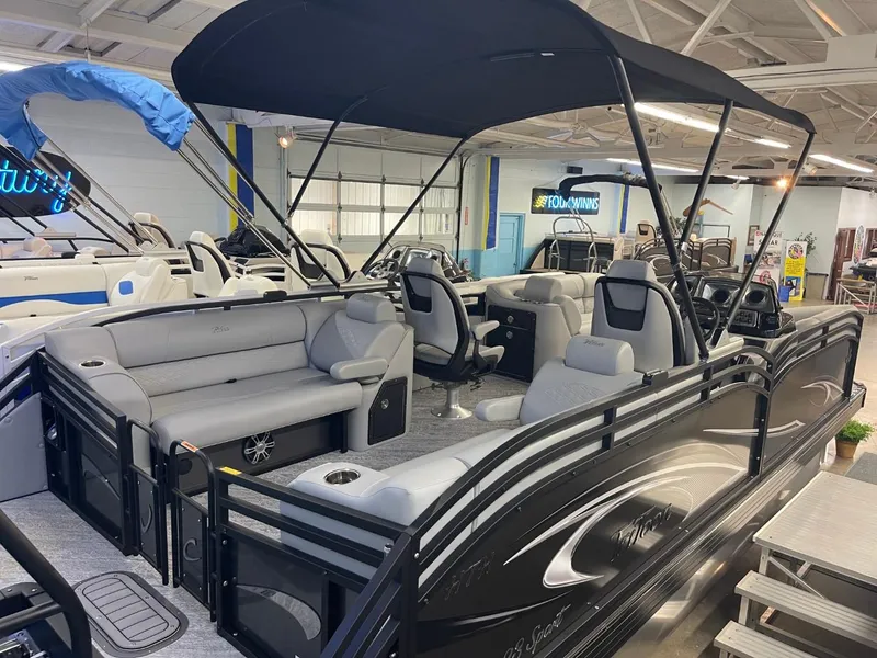 Slide: The Image of 2025 JC Neptoon 23 TT DSL pontoon boat with canopy in showroom. - 29