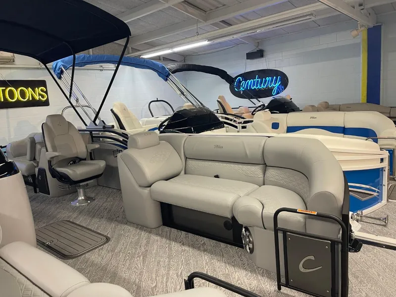Slide: The Image of 2025 JC Neptoon 23 TT DSL pontoon boat with luxurious seating in showroom. - 6