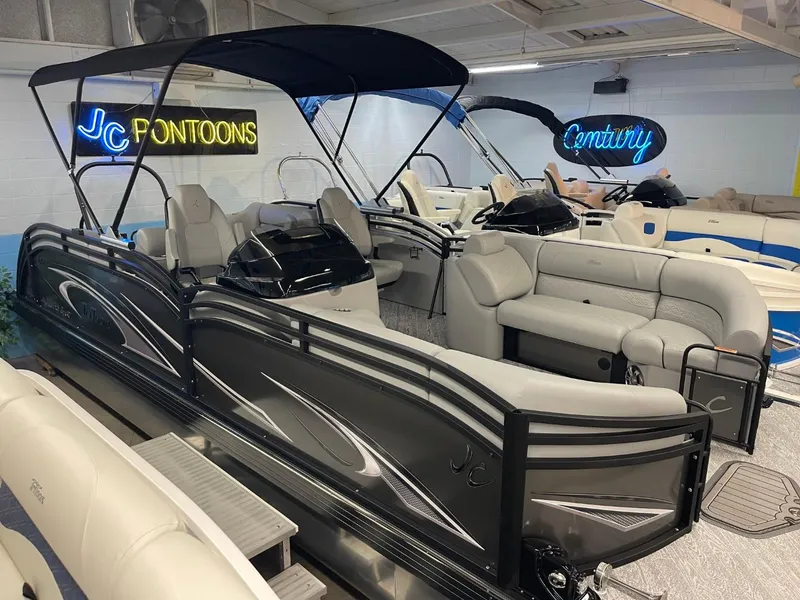 Slide: The Image of 2025 JC Neptoon 23 TT DSL pontoon boat in showroom with sleek design and comfortable seating. - 7