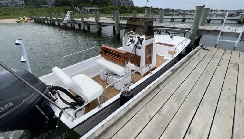 Slide: The Image of 2025 Metan 17 Davenport boat docked by wooden pier, featuring Yamaha outboard motor. - 3