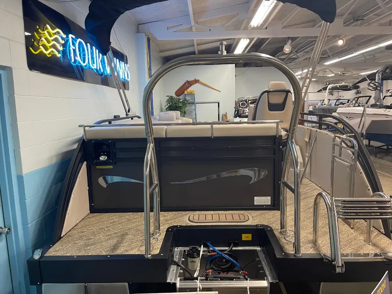Slide: The Image of 2025 JC Neptoon 23 TT LG pontoon boat interior at showroom display. - 12