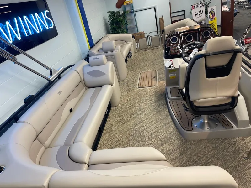 Slide: The Image of 2025 JC Neptoon 23 TT LG pontoon boat interior with plush seating and modern helm. - 15