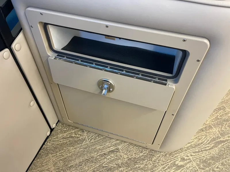 Slide: The Image of 2025 JC Neptoon 23 TT LG storage compartment with lock, beige interior design. - 20