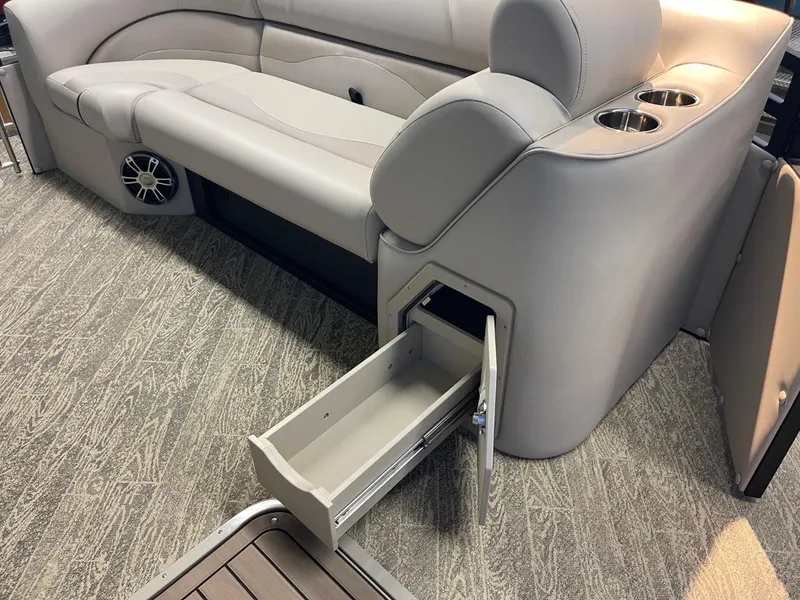 Slide: The Image of 2025 JC Neptoon 23 TT LG boat interior with storage drawer and cup holders. - 22