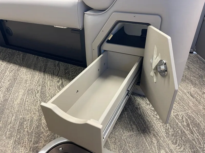 Slide: The Image of Open storage drawer in 2025 JC Neptoon 23 TT LG boat interior. - 23