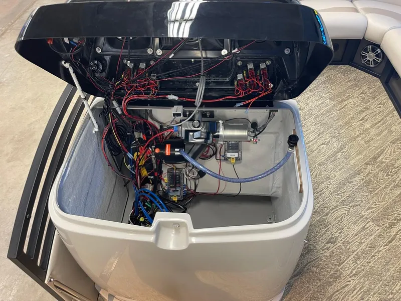 Slide: The Image of Open engine compartment of 2025 JC Neptoon 23 TT LG boat, showing wiring and components. - 25