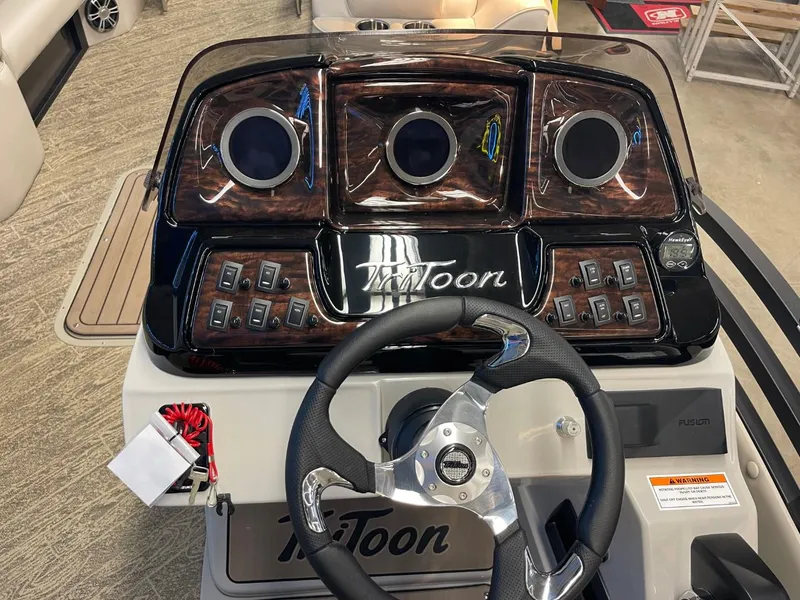 Slide: The Image of 2025 JC Neptoon 23 TT LG boat dashboard with steering wheel and control panel. - 27