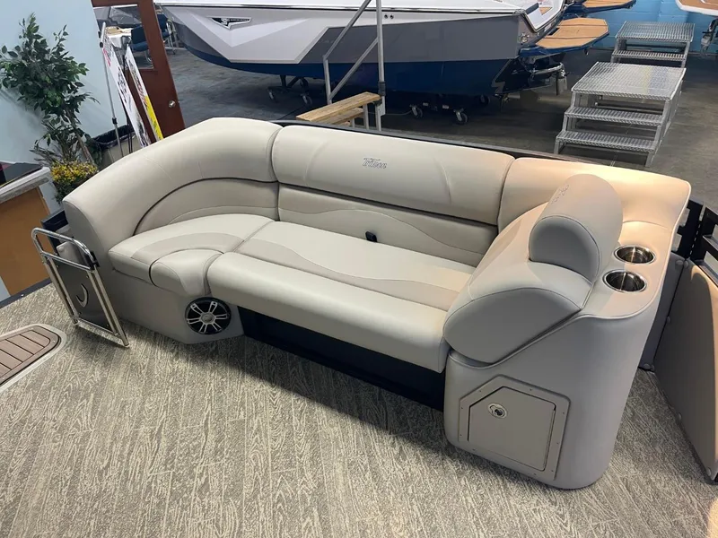 Slide: The Image of 2025 JC Neptoon 23 TT LG boat interior with beige seating and cup holders. - 29