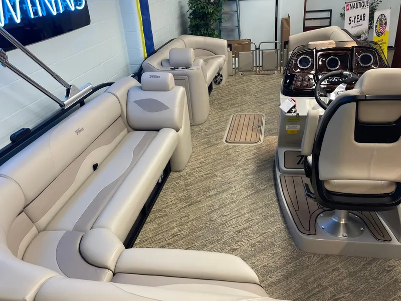 Slide: The Image of 2025 JC Neptoon 23 TT LG pontoon boat interior with plush seating and modern dashboard. - 32