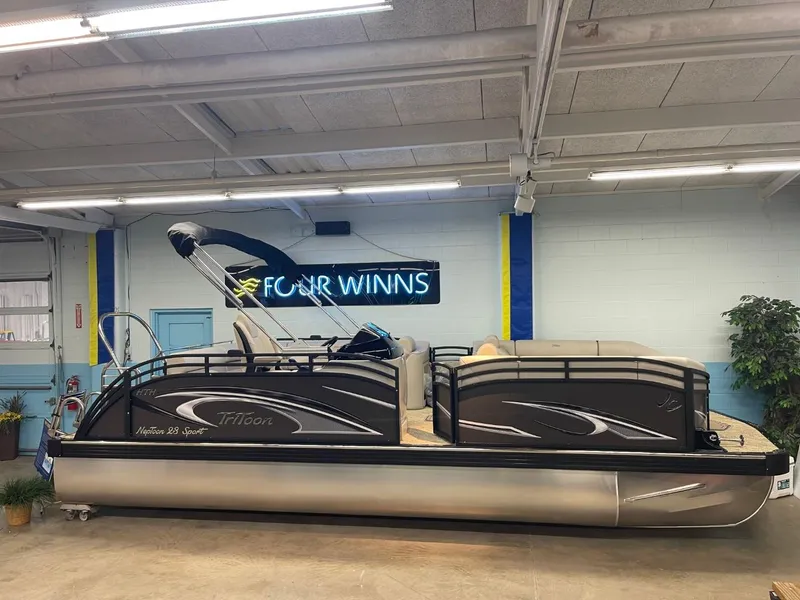 Slide: The Image of 2025 JC Neptoon 23 TT LG pontoon boat in showroom with Four Winns sign. - 4