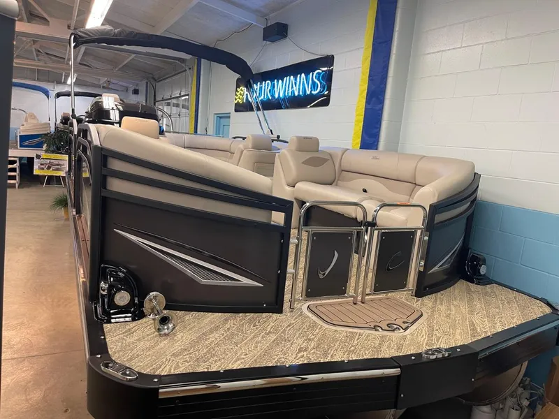 Slide: The Image of 2025 JC Neptoon 23 TT LG pontoon boat in showroom, beige seating, modern design. - 7