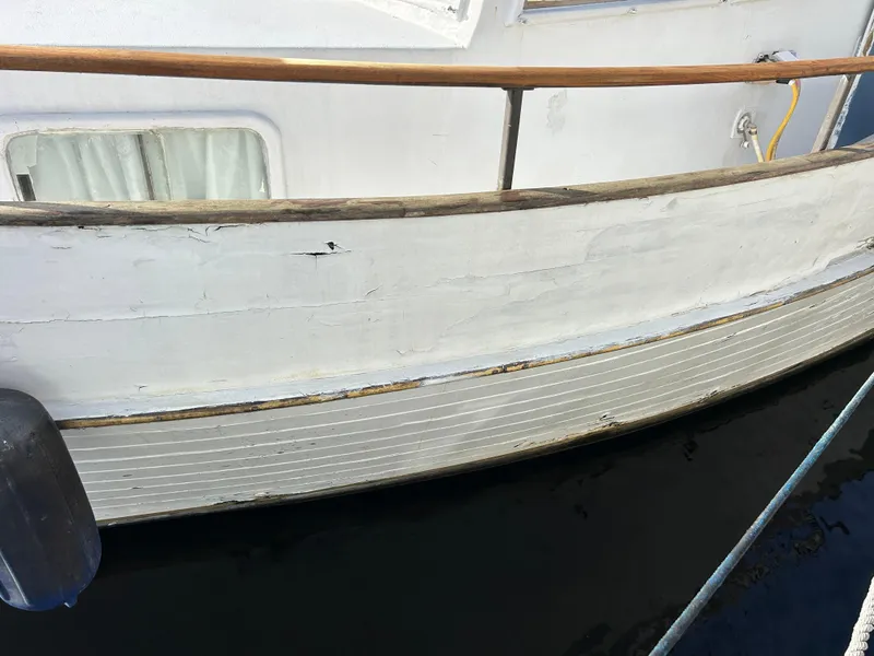 Slide: The Image of 1972 Grand Banks 42 Classic boat with wooden railing and white hull. - 10