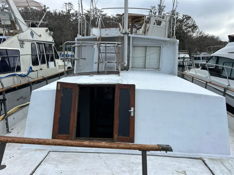 Slide: The Image of 1972 Grand Banks 42 Classic yacht docked, featuring wooden doors and spacious deck. - 16