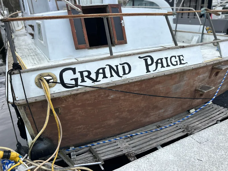 Slide: The Image of 1972 Grand Banks 42 Classic boat named "Grand Paige" docked at a marina. - 17