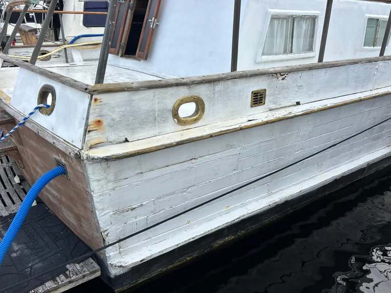 Slide: The Image of 1972 Grand Banks 42 Classic boat with weathered white exterior docked at marina. - 20