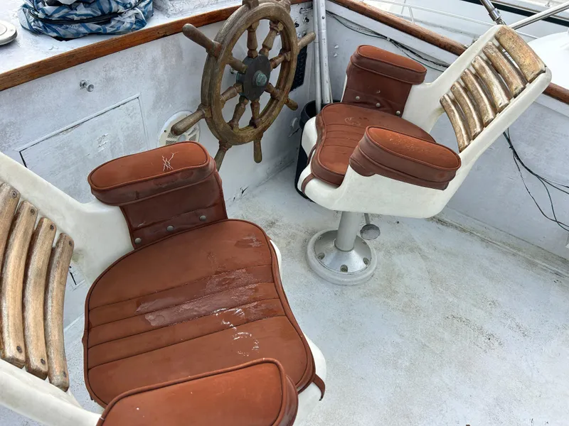 Slide: The Image of Vintage 1972 Grand Banks 42 Classic boat helm with wooden wheel and leather seats. - 23