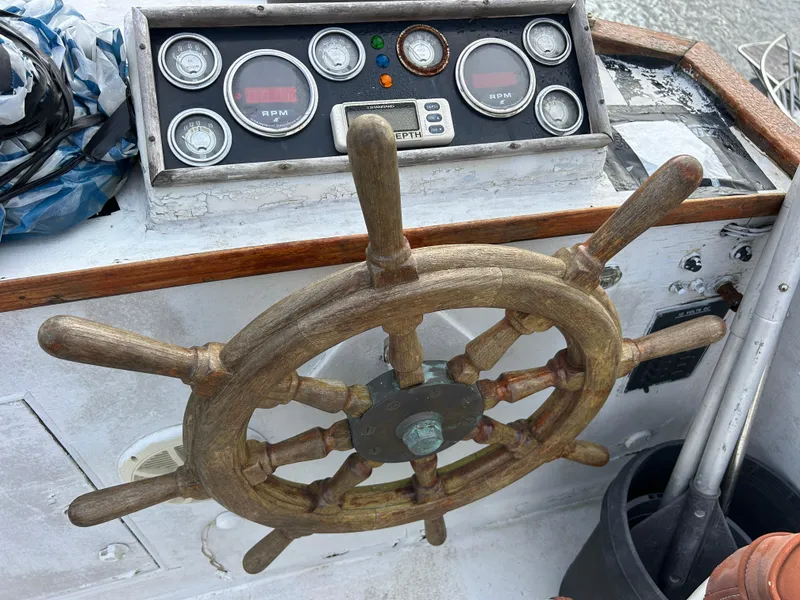 Slide: The Image of Wooden helm and gauges of a 1972 Grand Banks 42 Classic boat. - 25