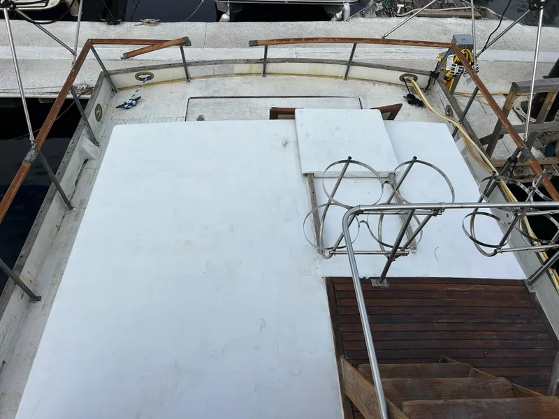 Slide: The Image of 1972 Grand Banks 42 Classic yacht deck with wooden railings and stairs. - 28