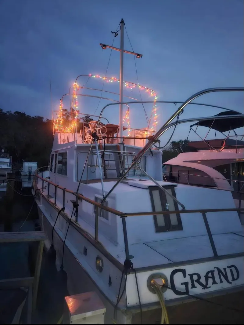 Slide: The Image of 1972 Grand Banks 42 Classic boat with festive lights at dusk. - 35