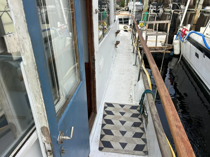 Slide: The Image of 1972 Grand Banks 42 Classic yacht deck with blue door and geometric mat. - 36