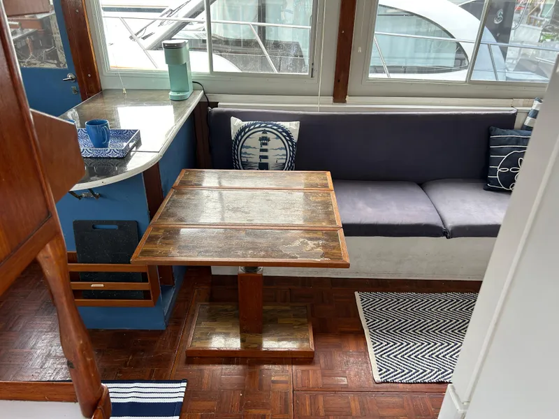 Slide: The Image of Interior of 1972 Grand Banks 42 Classic yacht with wooden table and cushioned seating. - 37