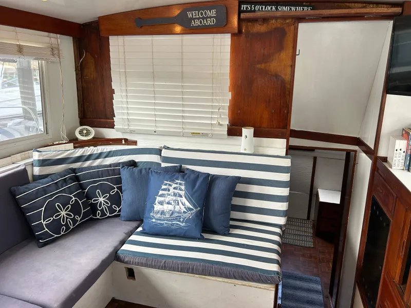 Slide: The Image of Interior of 1972 Grand Banks 42 Classic with nautical-themed cushions and wood paneling. - 38