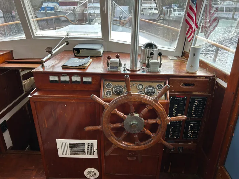 Slide: The Image of Vintage 1972 Grand Banks 42 Classic helm with wooden wheel and nautical instruments. - 41