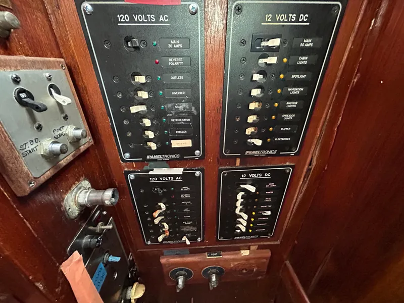 Slide: The Image of Electrical panel on a 1972 Grand Banks 42 Classic boat, featuring AC and DC switches. - 44