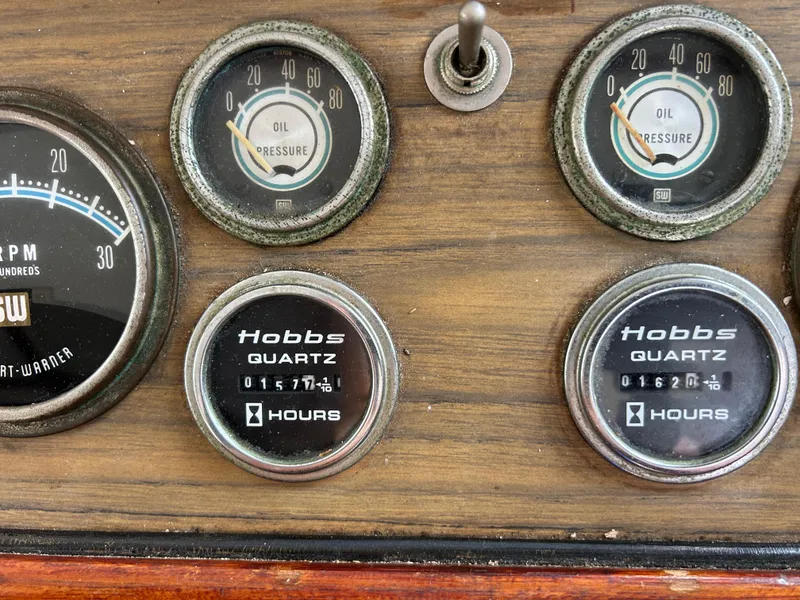 Slide: The Image of Dashboard of a 1972 Grand Banks 42 Classic with oil pressure and Hobbs quartz hour meters. - 45