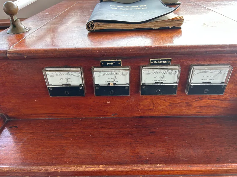 Slide: The Image of Vintage 1972 Grand Banks 42 Classic boat dashboard with analog gauges and wooden finish. - 46