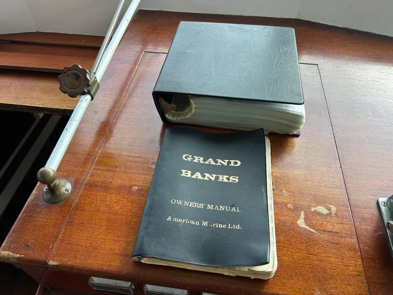Slide: The Image of Grand Banks 42 Classic 1972 owner's manual on wooden surface. - 47