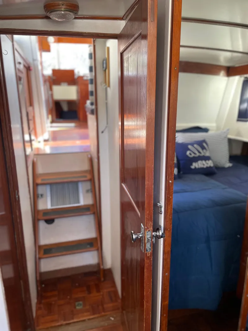 Slide: The Image of Interior of 1972 Grand Banks 42 Classic yacht with wooden finishes and cozy bedroom. - 50
