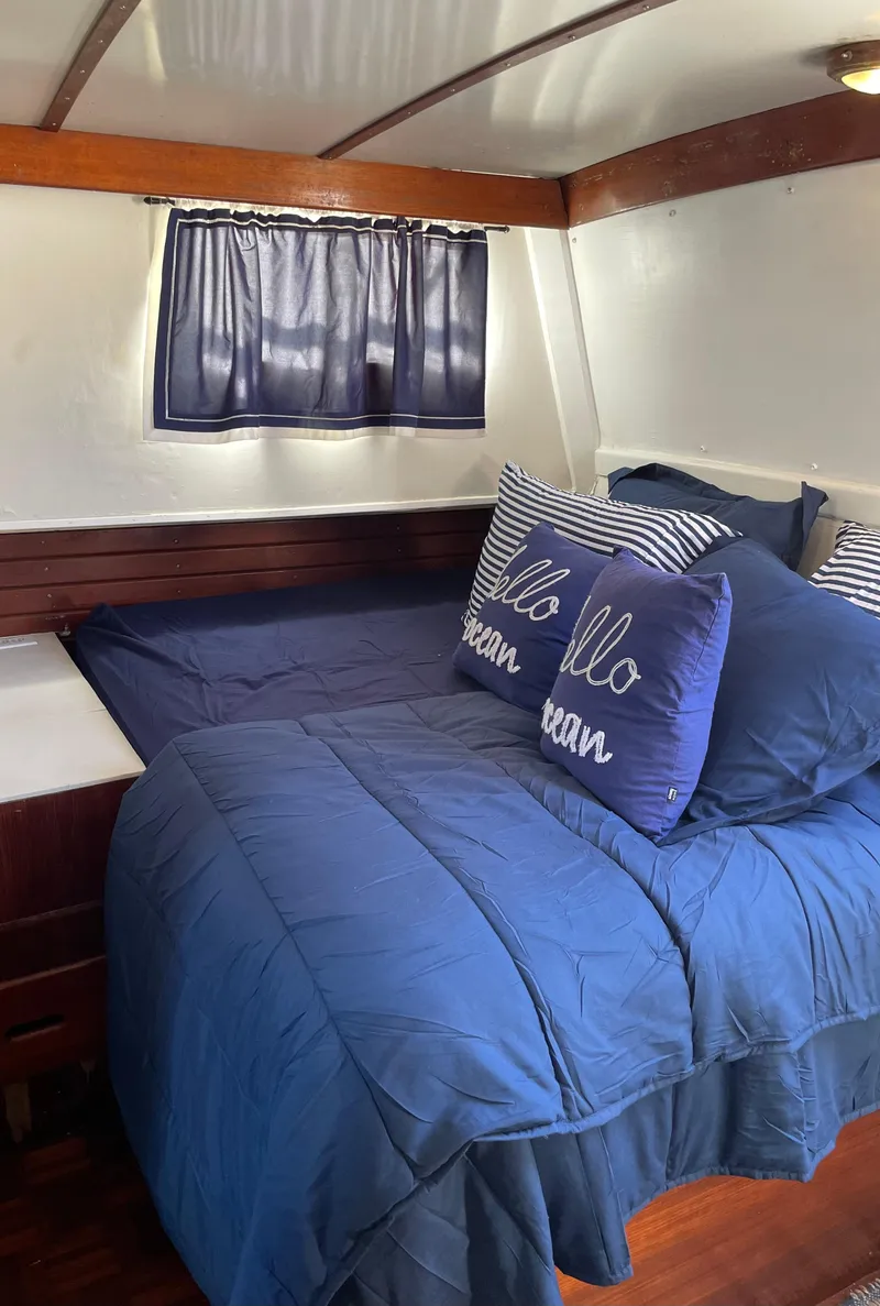 Slide: The Image of Cozy cabin bedroom in 1972 Grand Banks 42 Classic yacht with blue bedding. - 55