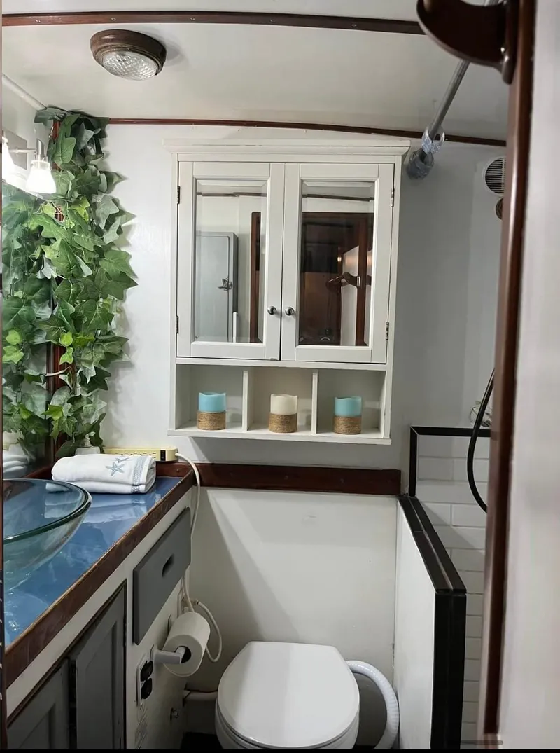 Slide: The Image of Vintage 1972 Grand Banks 42 Classic yacht bathroom with modern decor and greenery. - 58