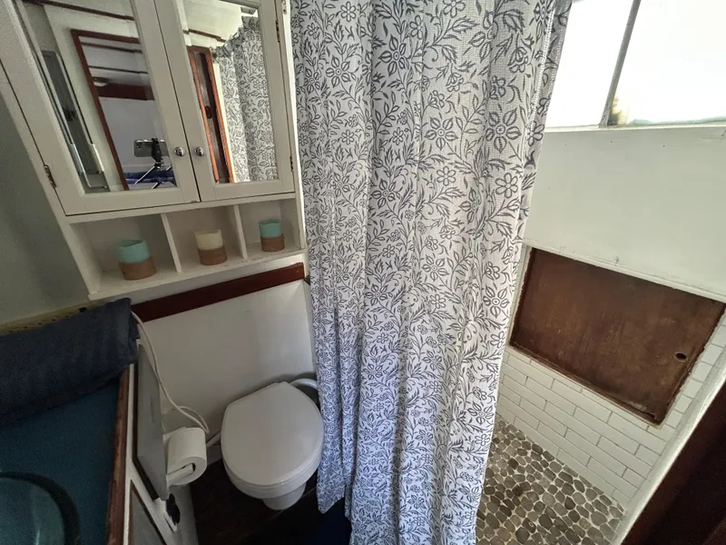 Slide: The Image of Bathroom interior of 1972 Grand Banks 42 Classic with floral shower curtain. - 59