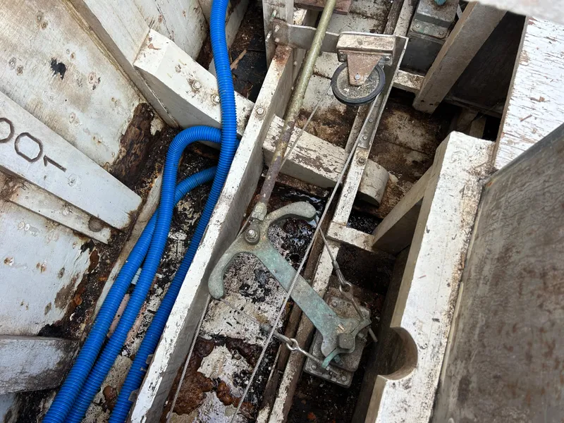 Slide: The Image of Interior view of 1972 Grand Banks 42 Classic boat showing mechanical components and blue hose. - 76