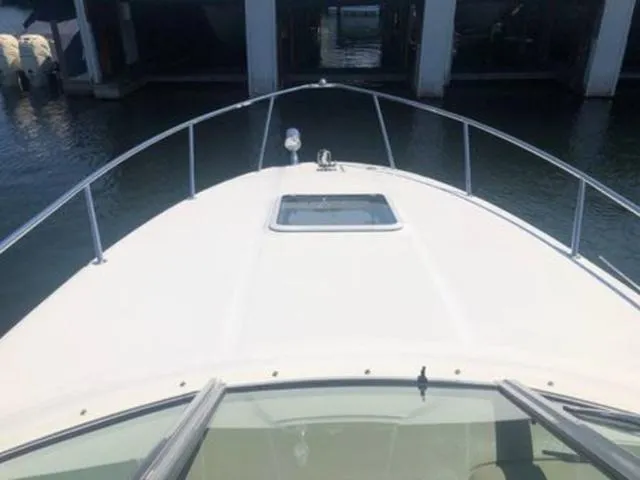 Slide: The Image of 2003 Sea Ray 260 Sundancer boat bow view at marina. - 11
