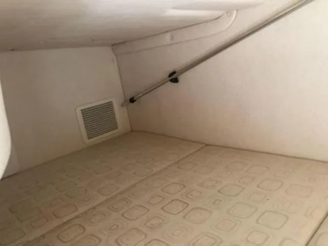 Slide: The Image of Interior cabin of 2003 Sea Ray 260 Sundancer with beige upholstery and vent. - 20