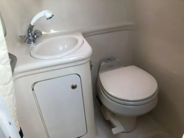 Slide: The Image of Compact bathroom in 2003 Sea Ray 260 Sundancer boat with sink and toilet. - 21