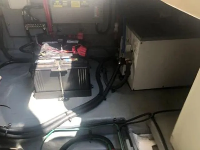 Slide: The Image of Engine compartment of a 2003 Sea Ray 260 Sundancer with visible battery and wiring. - 23