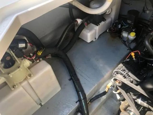 Slide: The Image of Engine compartment of 2003 Sea Ray 260 Sundancer boat, showing mechanical components. - 24