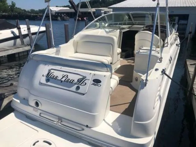 Slide: The Image of 2003 Sea Ray 260 Sundancer boat docked, featuring spacious seating and sleek design. - 5
